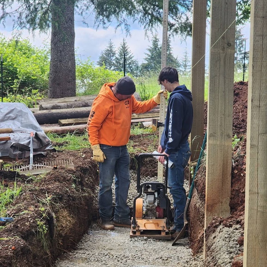 Our crew compacting a trench on a job site